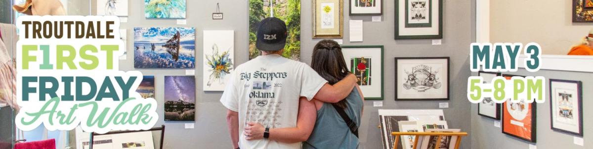 A couple looks at art inside a Troutdale gallery