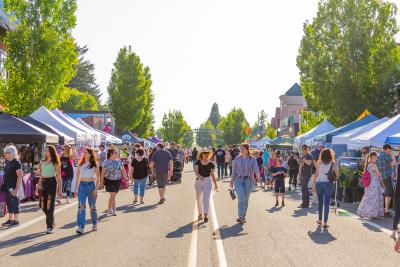 People stroll along the street in downtown Troutdale during First Friday