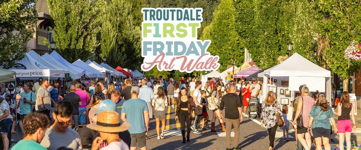 People walk along Historic Columbia River Highway in downtown Troutdale during First Friday